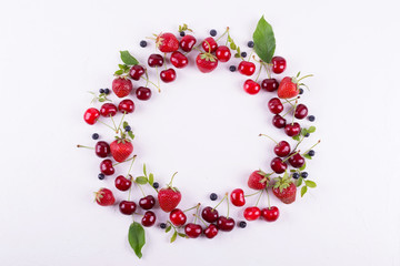 Obraz premium Summer concept. Flat lay, top view, copy space. Frame made of fresh berries. Strawberry, blueberry and sweet cherry