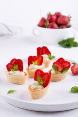 Sweet  waffle basket with cream cheese  and strawberries for summer  breakfast  over white background