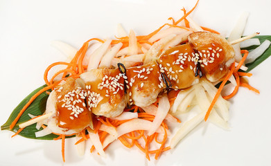 mini kebabs on skewer with chicken fillet and leek, served in Teriyaki sauce, with Beijing cabbage, carrots and sesame