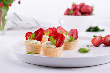 Sweet  waffle basket with cream cheese  and strawberries for summer  breakfast  over white background