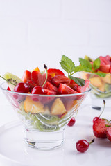 Healthy lifestyle. Two glasses of healthy mix fruit salad on white table background
