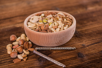 wooden bowl full of different muxture variety of nuts 