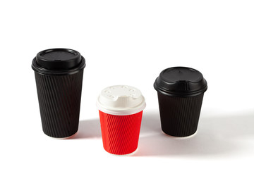 Black and red disposable coffee cups on white background with copy space