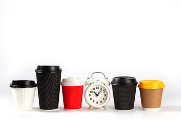 Retro alarm clock and disposable colorful coffee cups isolated on white background with copy space