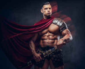 Brutal ancient Greece warrior with a muscular body in battle uniforms