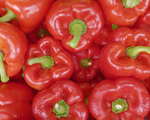 organic red peppers top view, food background