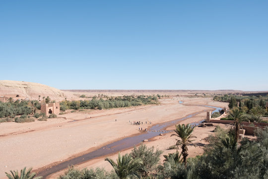 Morocco: photo of old town in sandy mountains in hot summer with blue sky 