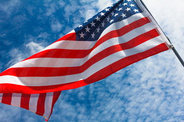 Star-stripped American flag against the blue sky.