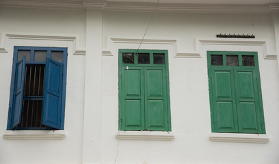 Fototapeta premium Three windows on a white ancient building