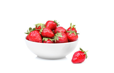 a lot of strawberries in a white bowl on a white background isolated