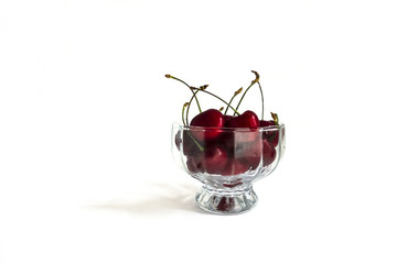 ripe cherries in a glass container. on white background, isolated
