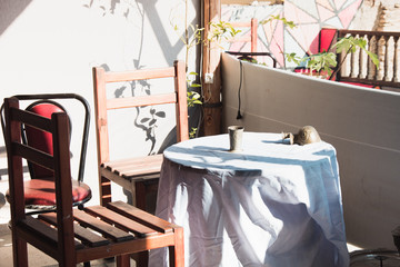 old outdoor cafe with table and chairs in town at hot summer