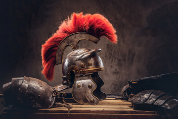Complete combat equipment of the ancient Greek warrior lie on a box of wooden boards. - obrazy, fototapety, plakaty