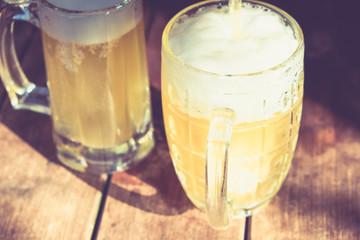 Close-up cold beers with foam and drops.