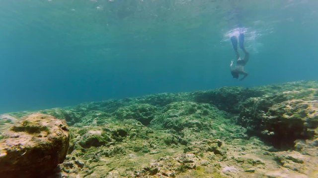 Man dive underwater with snorkel and mask