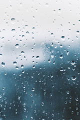 Raindrops on the window glass, blue background