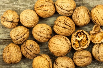 Walnuts on an old wooden board. Healthy food. Autumn harvest.