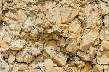Textured stone background Rubble ballast in natural form in the rock wall
