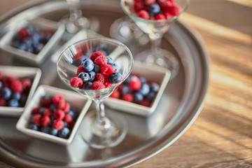 Berries of blueberries, raspberries in a beautiful vase on the table