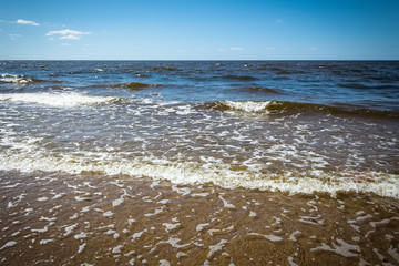 The coast of the Baltic Sea with small waves on a sunny day