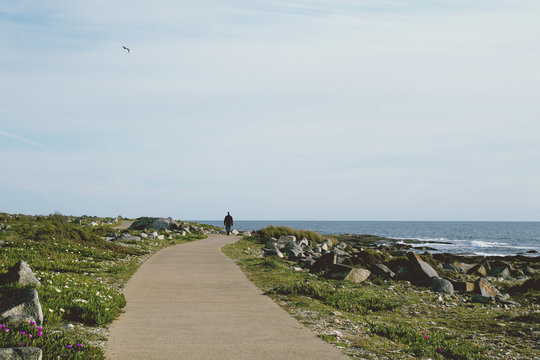 Man walking alone by the sea