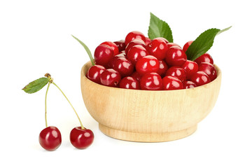 ripe juicy cherry berries with leaves in a plate