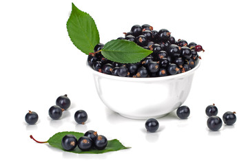 ripe juicy currant branches in a plate on white table