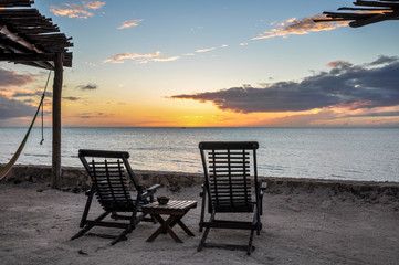 Wooden Beach Chairs overlooking sunset at Holbox Island, Mexico