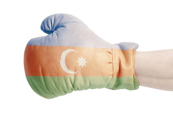Azerbaijani flag on boxing gloves wearing in male hand