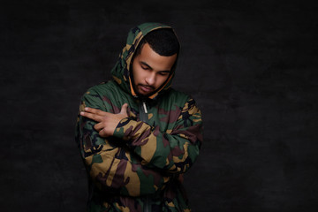 Handsome African-American guy wear military jacket.