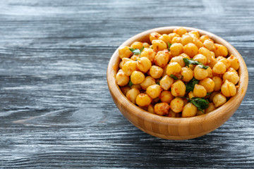 Spicy chickpeas in a wooden bowl.