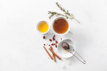Tea in a Cup with cinnamon, honey and rosehip. Copy space text