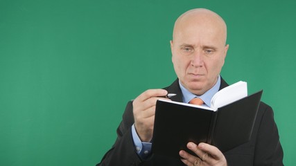 Businessman Image Working With Agenda and Green Screen in Background