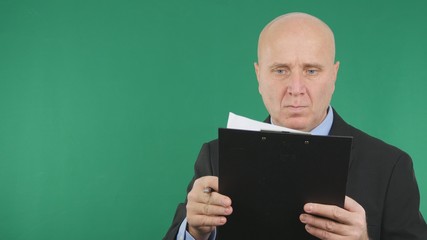 Serious Businessman Image Reading Documents With Green Screen Background