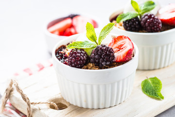 Crumble pie with berry mix, granola and ice cream.