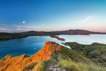 Top view of 'Gili Lawa' in a morning with blue sea and tourist boats, Komodo Island (Komodo National Park), Labuan Bajo, Flores, Indonesia © Thrithot