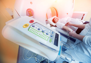 Doctor and patient in the room of computed tomography at hospital.