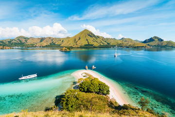 Top view of 'Kelor Island' in an afternoon before sunset with turquoise sea and tourist boats, Komodo Island (Komodo National Park), Labuan Bajo, Flores, Indonesia
