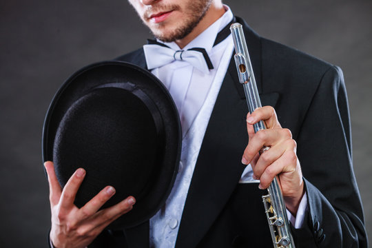 Elegantly dressed musician holding flute