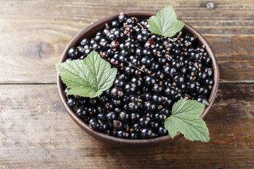 natural antioxidant fresh organic currant on a wooden background, space for text.