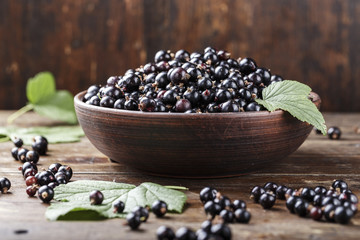 natural antioxidant fresh organic currant on a wooden background, space for text.