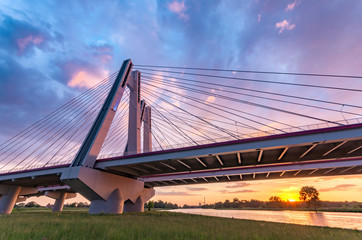 Cable stayed bridge over Vistula river, Krakow, Poland, beautiful colorful sunset