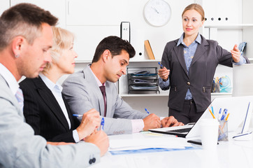 Businesswoman explaining to workgroup plans