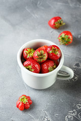 Fresh garden strawberry in enameled mug