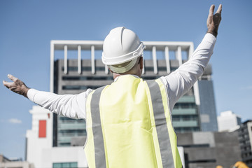 Senior foreman in glasses doing his job at building area on sunn