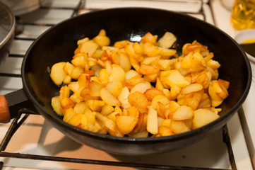 Fried potatoes on black frying pan