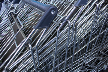 Ferrous spokes of baskets of light carts of supermarket