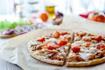 hot fresh homemade traditional italian pizza on wooden table. wallpaper for pizzeria and cooking food concept. closeup