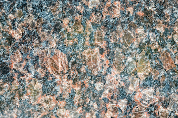 Granite, basalt or marble stone crystal texture of polished gravestone. The macro shot is made by means of stacking technology
