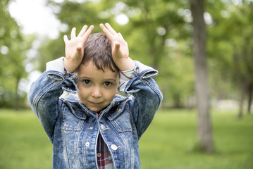 Handsome little boy posing in the park